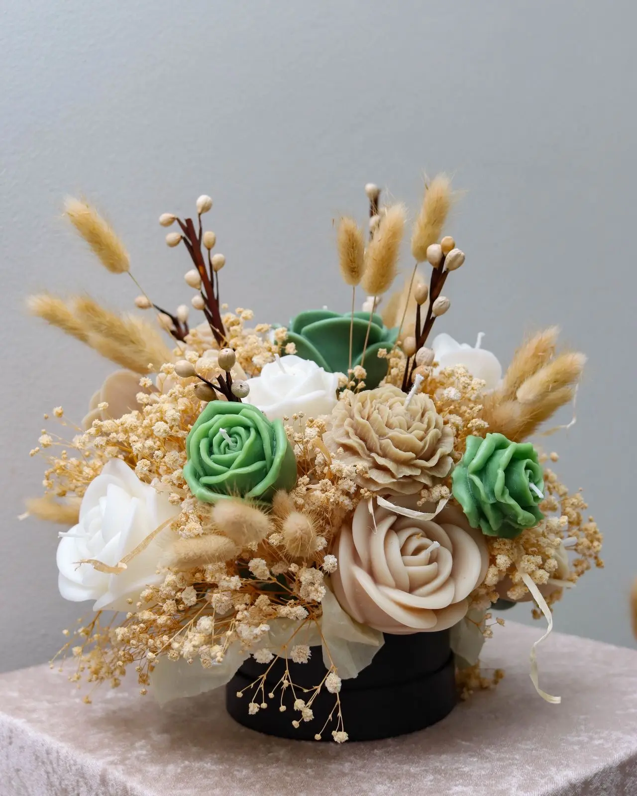 Medium candle bouquet with white, green and nude roses.